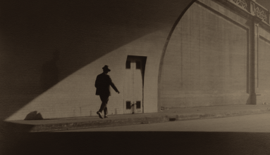 man walking out of tunnel